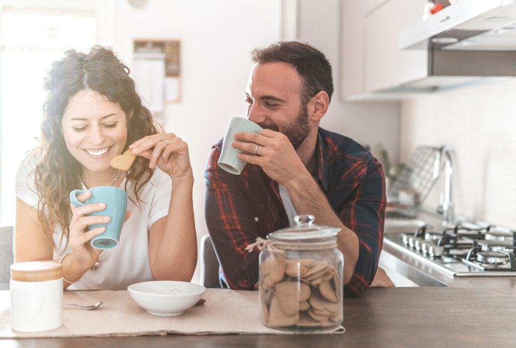 young couple having coffee and cookies