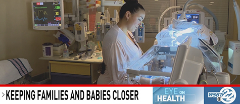 Mother cares for her newborn in a couplet care room, keeping parent and baby together.