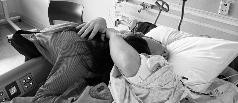 Ryan Hunt hugs his daughter in his hospital room.